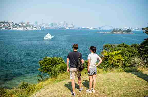 Sydney - Couple enjoying scenic views across Sydney Harbour along the Hermitage Foreshore Walk, Vaucluse Destiantion NSW Sydney - Couple enjoying scenic views across Sydney Harbour along the Hermitage Foreshore Walk, Vaucluse Destiantion NSW
