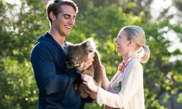 Man and woman holding a koala. Photo Credit: South Australian Tourism Commission